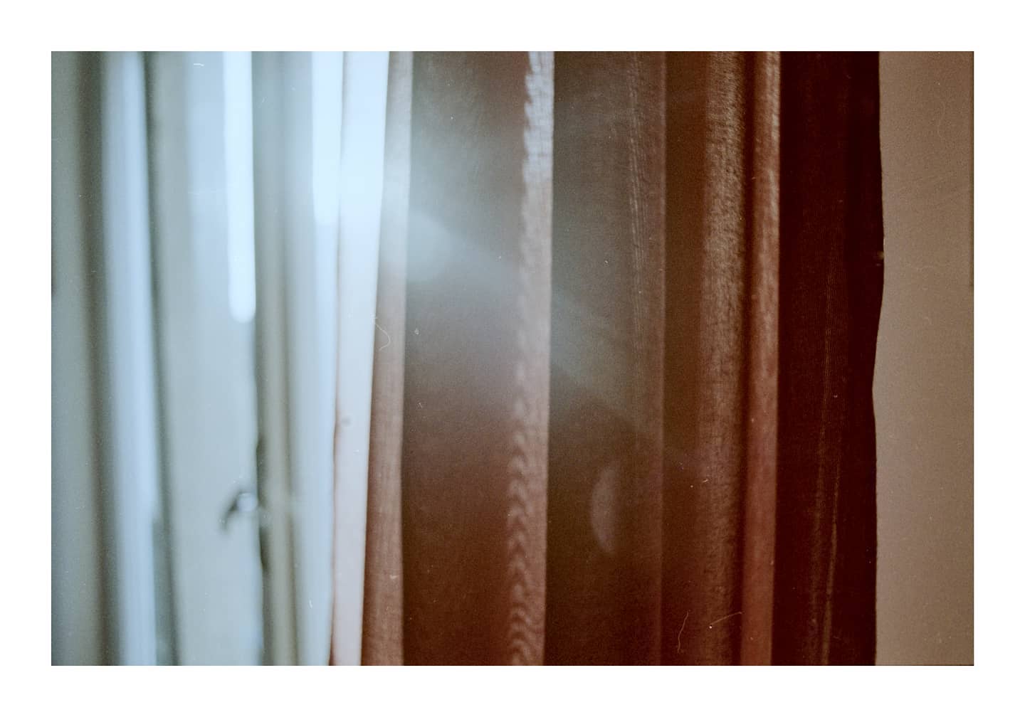 Warm light filtering through a curtain
