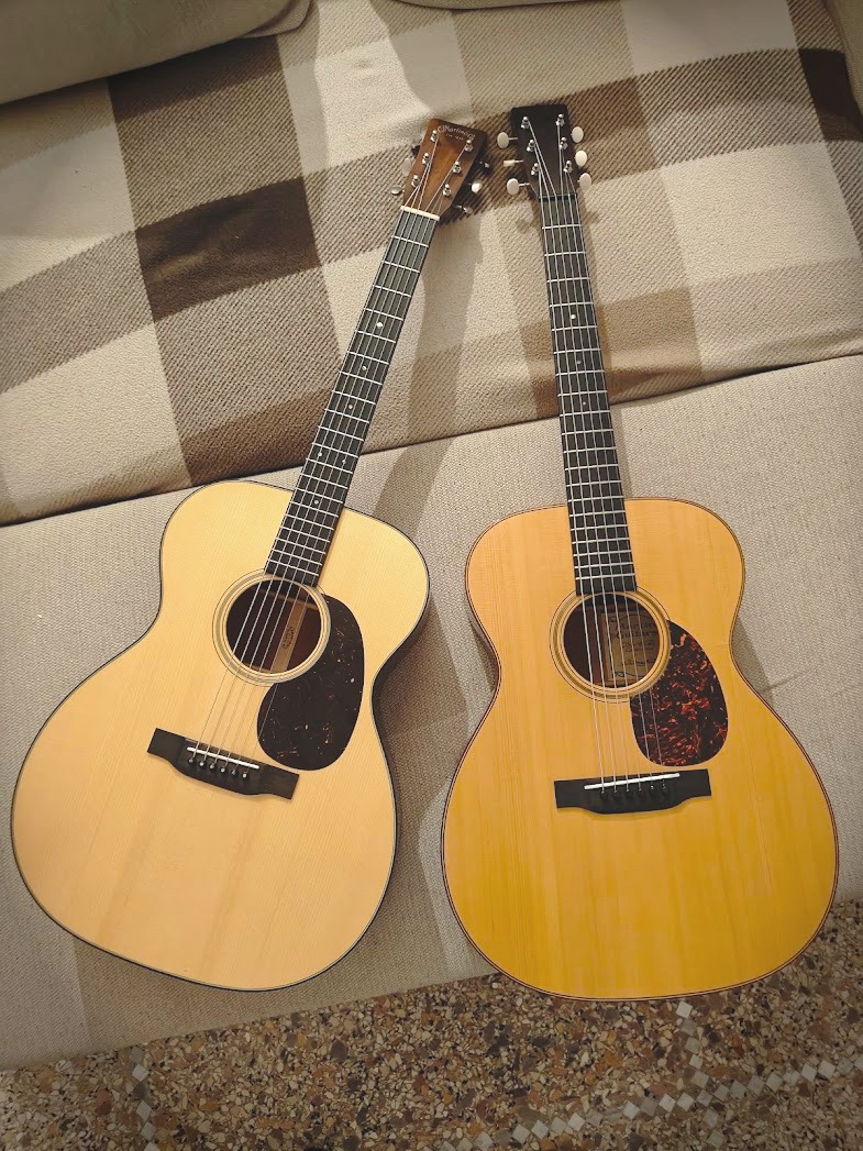 Two acoustic guitars side by side